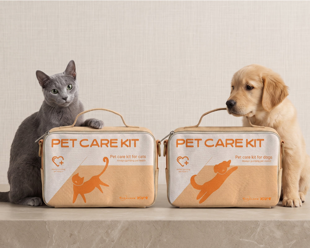 Two beige and orange pet care kits, one with a cat illustration and one with a dog illustration, displayed on a stone ledge with a gray cat on the left and a golden retriever on the right.